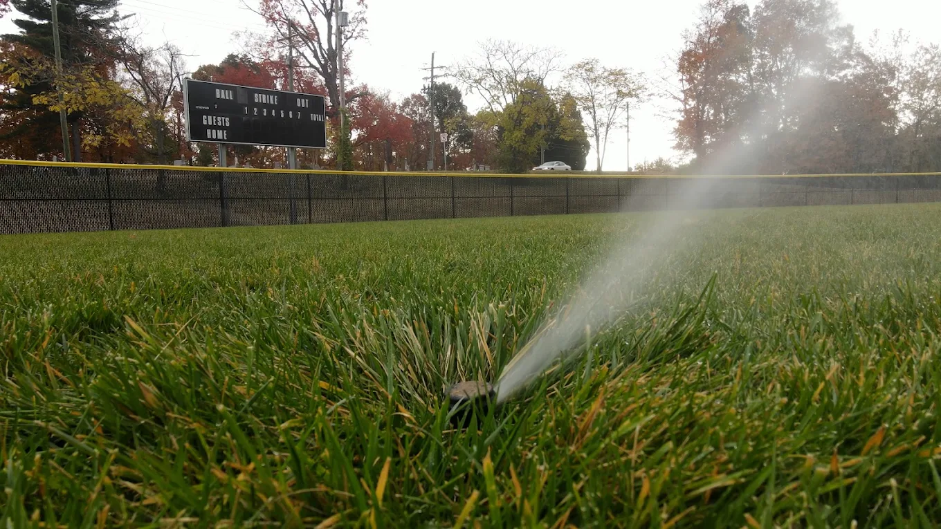 Irrigation watering a field in the late afternoon