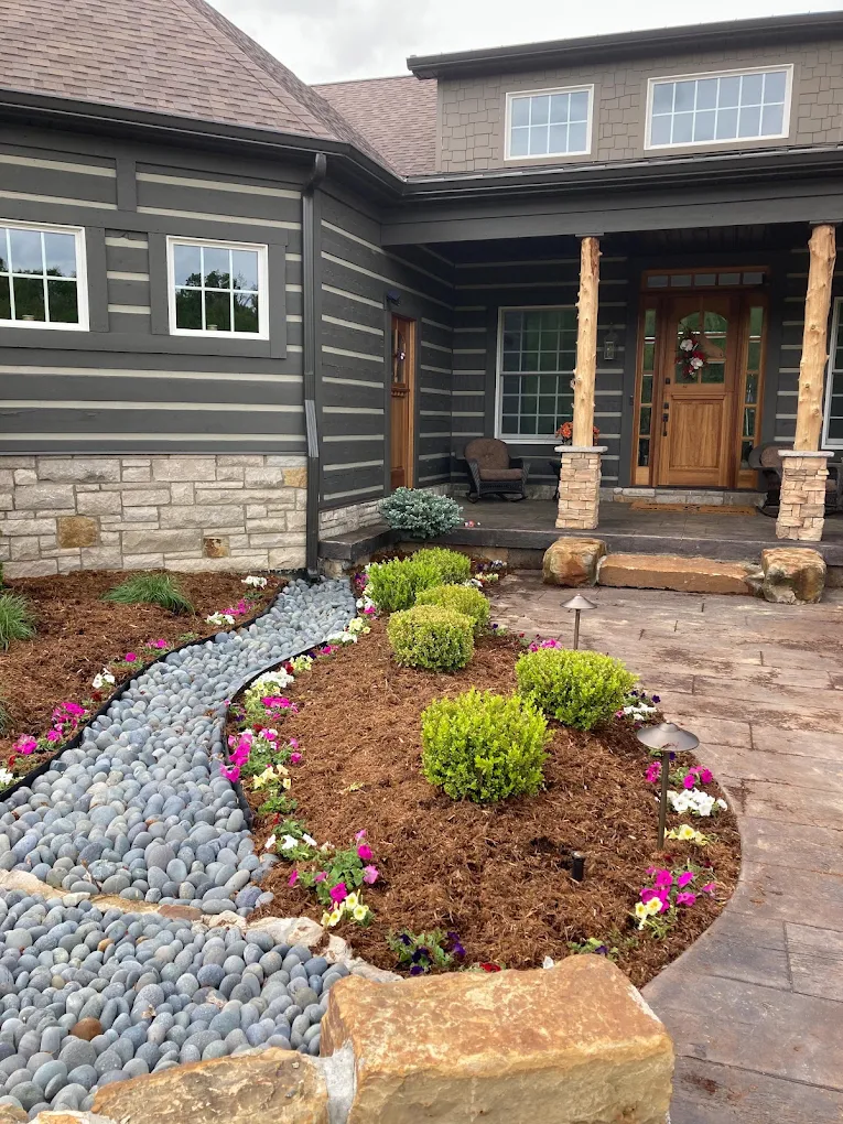 Lex planting and stone detail around a home's front entrance
