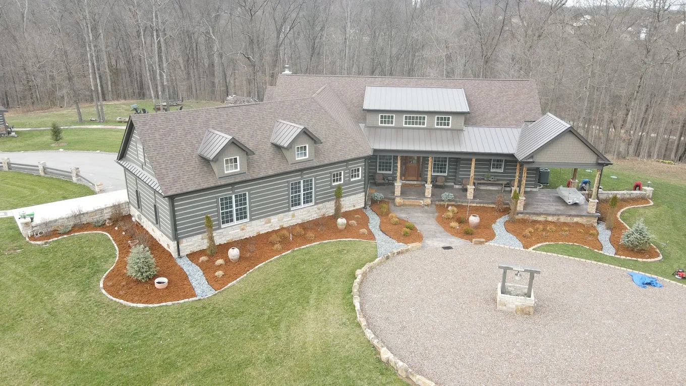 Finished planting, stone borders and lawn around a home