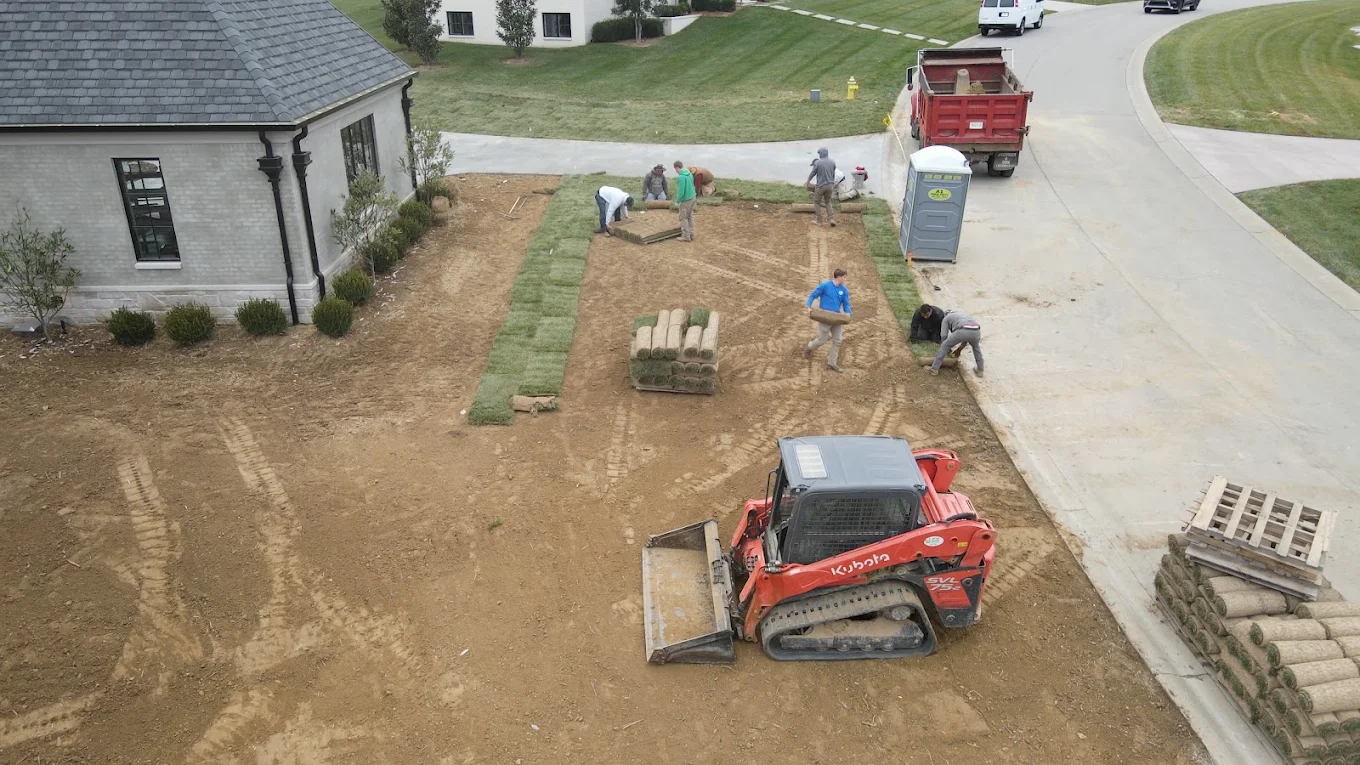 Lex crews and equipment working together to install a lawn around a home